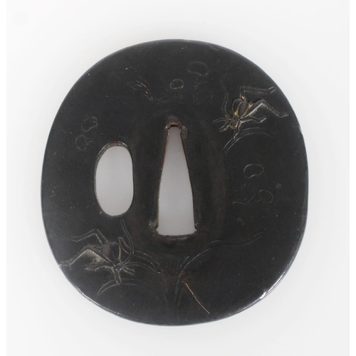 555 - An 18th century bronze tsuba of oval form, decorated with spiders and insects in low relief with inc... 