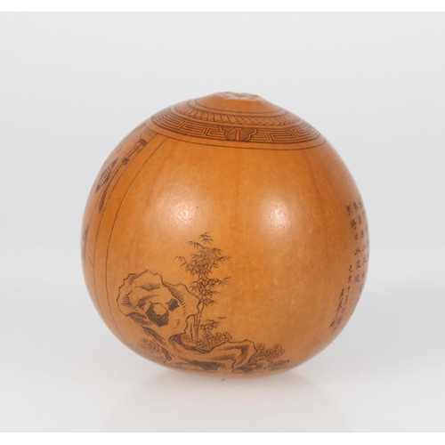 559 - Very finely carved near spherical gourd with inked incised lines depicting a man with a dog’s ... 