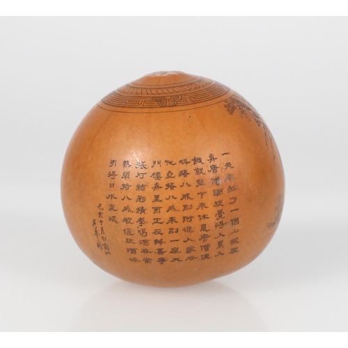 559 - Very finely carved near spherical gourd with inked incised lines depicting a man with a dog’s ... 