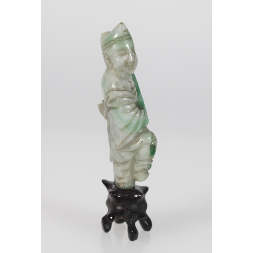 560 - A 19th century celadon green jade figure of a scholar holding a scroll whilst balancing on one foot,... 