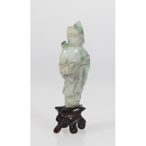 560 - A 19th century celadon green jade figure of a scholar holding a scroll whilst balancing on one foot,... 