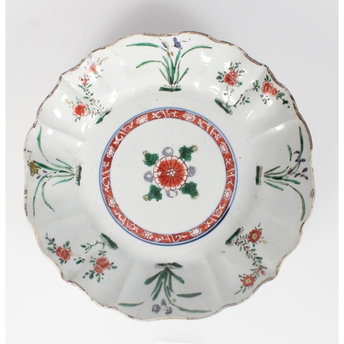 582 - 17th century Oriental dish decorated in the Kakiemon style with iron red, green and blue purple enam... 