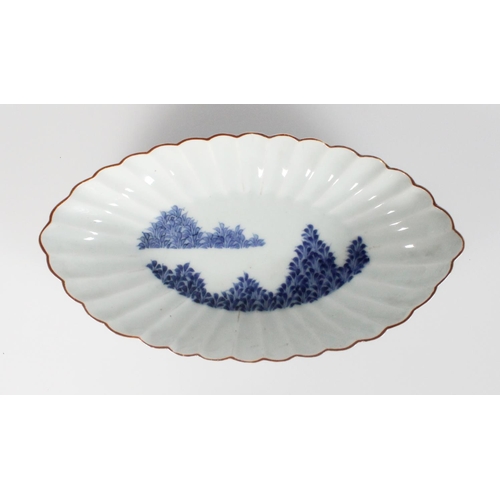 588 - Finely painted Japanese Arita dish of oval fluted form, the centre decorated with two banks of grass... 