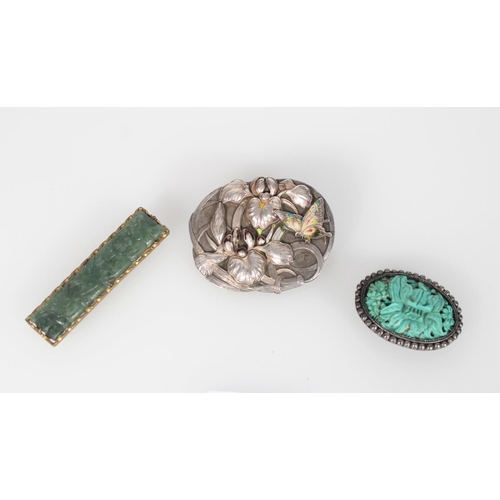 599 - Three pieces of Chinese jewellery, a green jade carved floral panel mounted as a tie pin, an oval tu... 