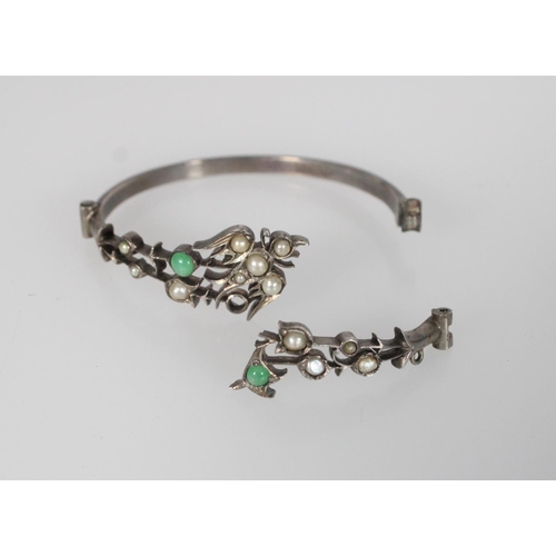 600 - Pair of Chinese hinged silver bracelets decorated with pearls and jade, with a bird to the centre of... 