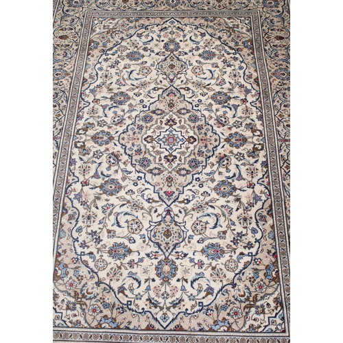 645 - Persian Kashan carpet rug, cream ground with central shaped foliate medallion surrounded by further ... 