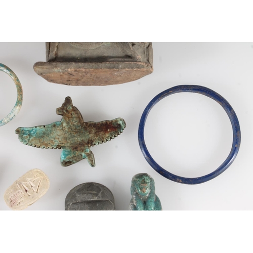 486 - Egyptian faience style winged goddess, 7.5cm long, two bangles, a small ushabti figure (af), four sc... 