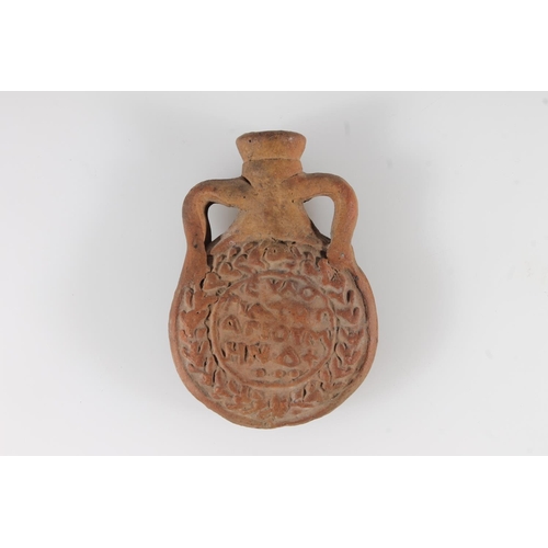 487 - Byzantine Coptic terracotta moulded ampulla with depiction of a saint, 9.5cm tall.