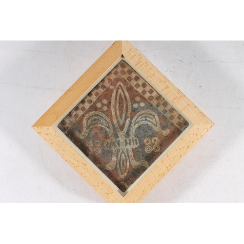 495 - Iznik glazed pottery half tile, 22cm long, another tile with Fleur di Lis design, held in wooden fra... 