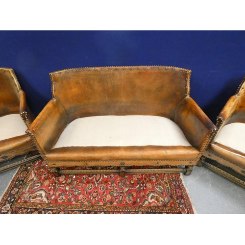 420 - 20th century Arts and Crafts two seater leather sofa along with two leather tub armchairs of studded... 