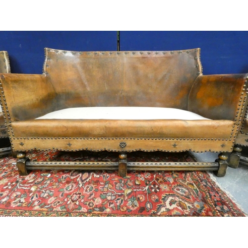 420 - 20th century Arts and Crafts two seater leather sofa along with two leather tub armchairs of studded... 