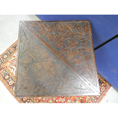 422 - Antique oak envelope table, the top carved with scrolling foliage and embellished with pokerwork des... 