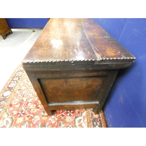 423 - Antique oak three panelled coffer of squat proportions, the paneled front having incised diamond mot... 