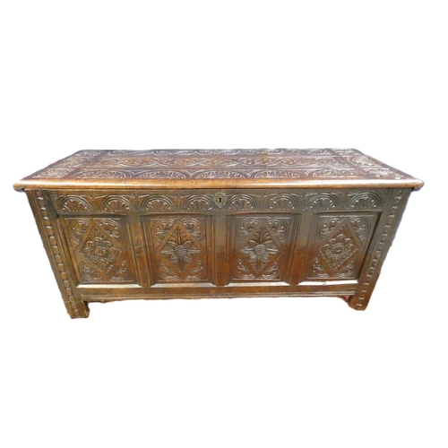 424 - 18th century oak coffer, with four panels with incised diamond motifs and central rosettes, the top ... 