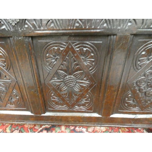 424 - 18th century oak coffer, with four panels with incised diamond motifs and central rosettes, the top ... 