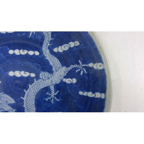 532 - Chinese blue and white porcelain dragon plate, late Qing period, the five clawed dragon amongst clou... 