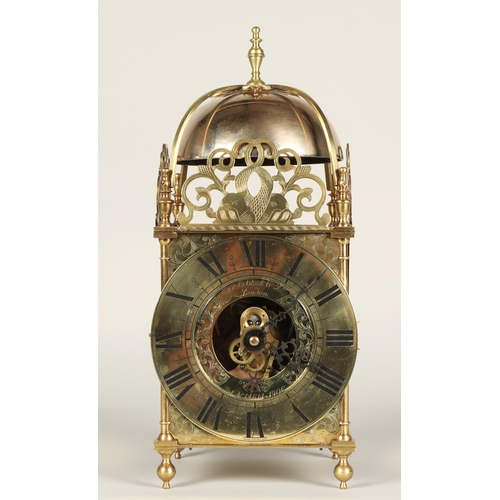 175 - Eureka electric lantern clock, the brass chapter ring enclosing a glazed centre with foliate engrave... 