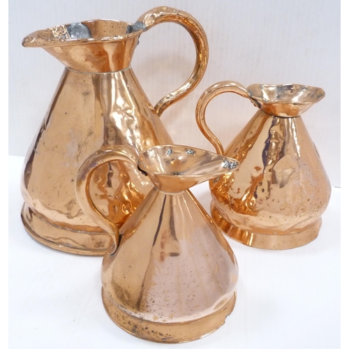 3 - Three antique copper measuring jugs of conical shape comprising a two-gallon jug, stamped 'ER', and ... 