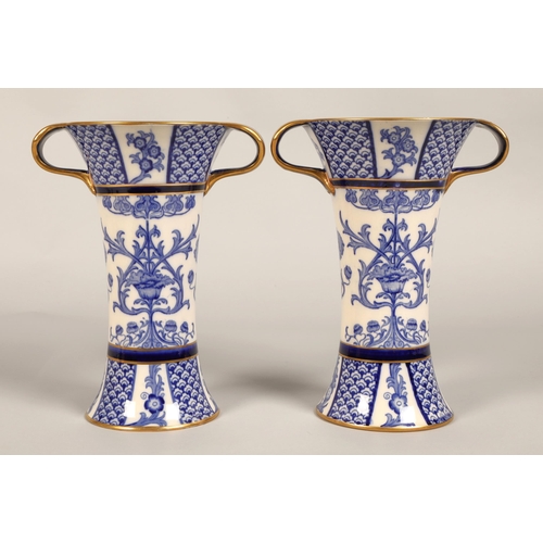 2 - Pair of MacIntyre vases, flared form with looped handles, blue and white floral design, factory stam... 