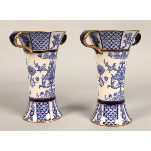 2 - Pair of MacIntyre vases, flared form with looped handles, blue and white floral design, factory stam... 