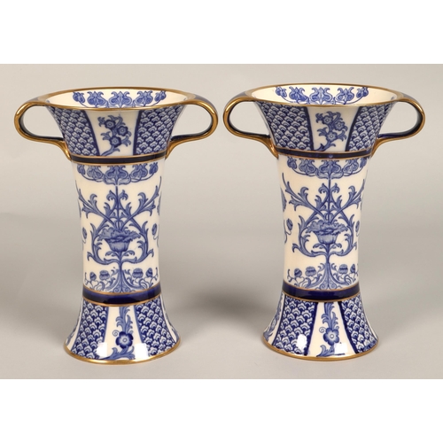 2 - Pair of MacIntyre vases, flared form with looped handles, blue and white floral design, factory stam... 