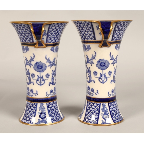 2 - Pair of MacIntyre vases, flared form with looped handles, blue and white floral design, factory stam... 