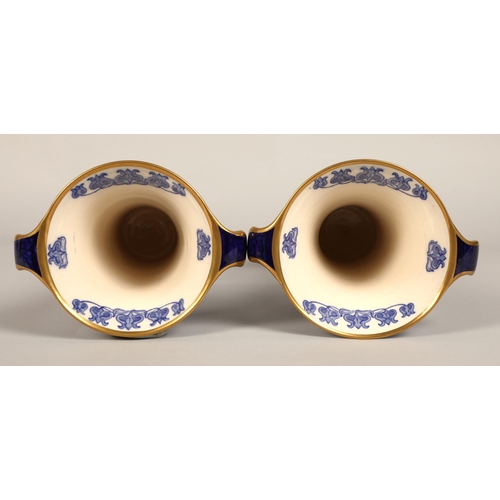 2 - Pair of MacIntyre vases, flared form with looped handles, blue and white floral design, factory stam... 