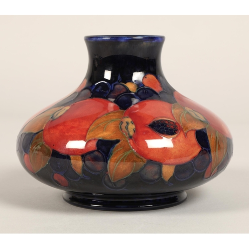 5 - Moorcroft pottery vase, of squat form, blue ground in the pomegranate pattern, impressed mark with b... 