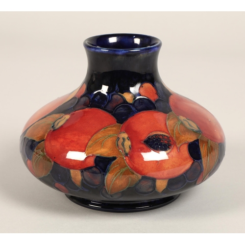 5 - Moorcroft pottery vase, of squat form, blue ground in the pomegranate pattern, impressed mark with b... 