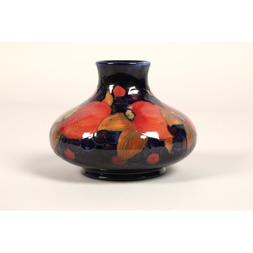 5 - Moorcroft pottery vase, of squat form, blue ground in the pomegranate pattern, impressed mark with b... 