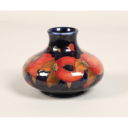 5 - Moorcroft pottery vase, of squat form, blue ground in the pomegranate pattern, impressed mark with b... 