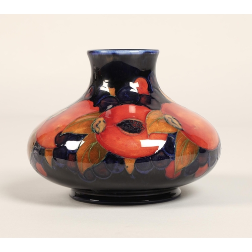 5 - Moorcroft pottery vase, of squat form, blue ground in the pomegranate pattern, impressed mark with b... 