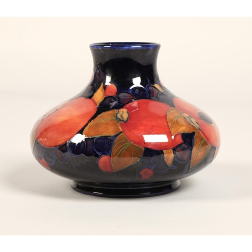 5 - Moorcroft pottery vase, of squat form, blue ground in the pomegranate pattern, impressed mark with b... 