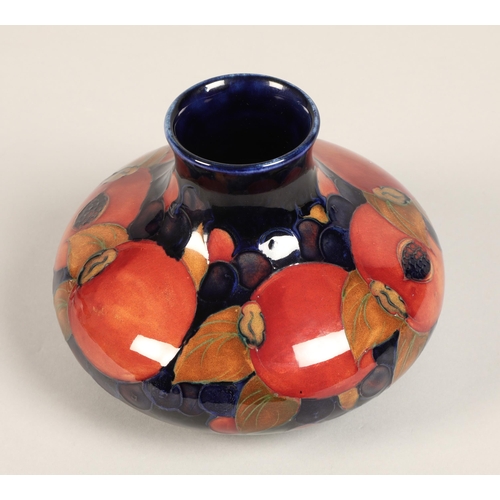 5 - Moorcroft pottery vase, of squat form, blue ground in the pomegranate pattern, impressed mark with b... 