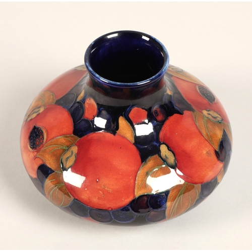 5 - Moorcroft pottery vase, of squat form, blue ground in the pomegranate pattern, impressed mark with b... 