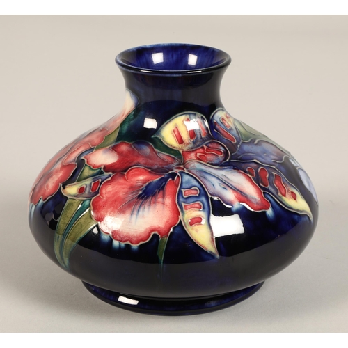 11 - Moorcroft pottery vase, of squat form, blue ground in the iris pattern, impressed mark with blue sig... 