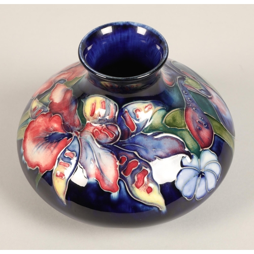 11 - Moorcroft pottery vase, of squat form, blue ground in the iris pattern, impressed mark with blue sig... 