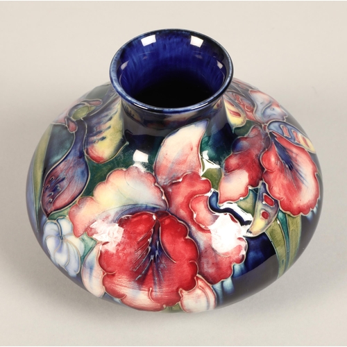 11 - Moorcroft pottery vase, of squat form, blue ground in the iris pattern, impressed mark with blue sig... 