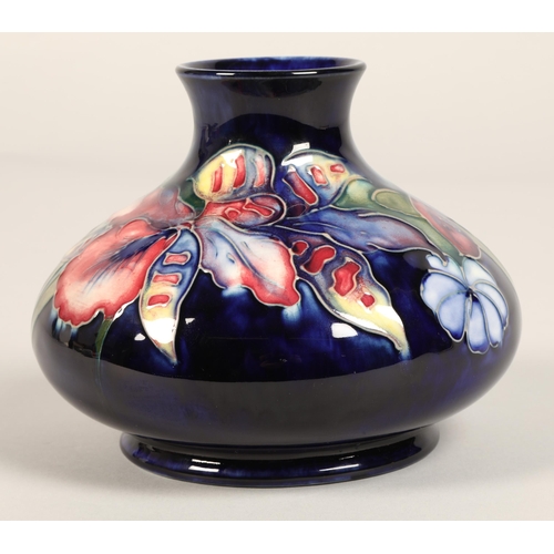 11 - Moorcroft pottery vase, of squat form, blue ground in the iris pattern, impressed mark with blue sig... 