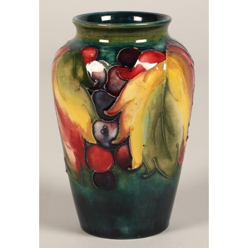 8 - Moorcroft pottery vase of baluster form decorated in the leaf & berry pattern, 13cm high.