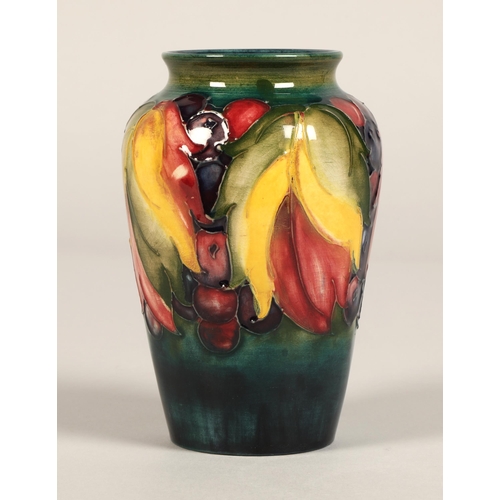 8 - Moorcroft pottery vase of baluster form decorated in the leaf & berry pattern, 13cm high.