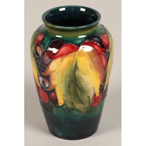 8 - Moorcroft pottery vase of baluster form decorated in the leaf & berry pattern, 13cm high.