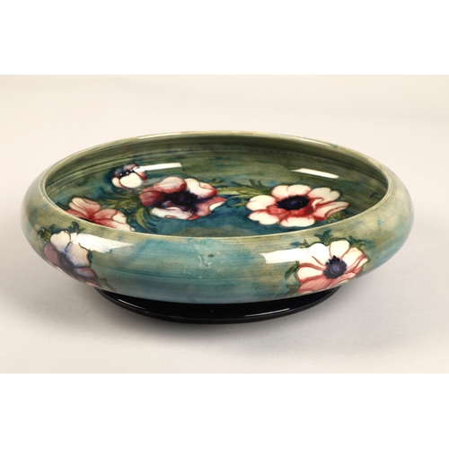 14 - Moorcroft shallow pottery bowl in the anemone pattern on blue and green ground, impressed marks and ... 