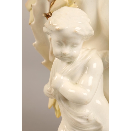 232 - Moore Bros vase, three cupids supporting a bowl,20cm high.