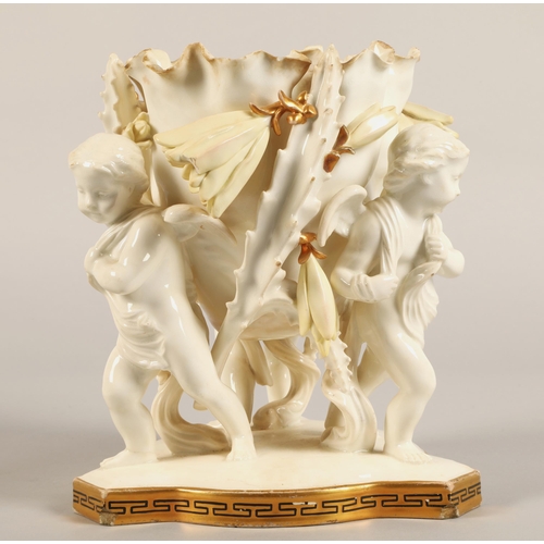 232 - Moore Bros vase, three cupids supporting a bowl,20cm high.