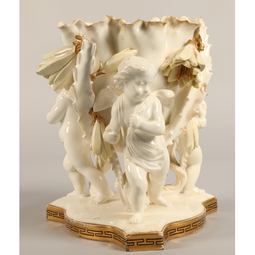 232 - Moore Bros vase, three cupids supporting a bowl,20cm high.