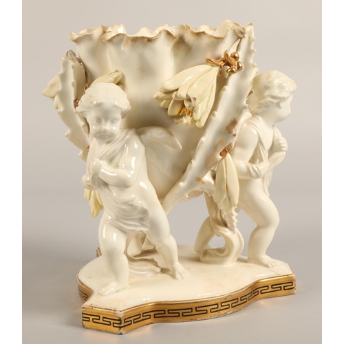 232 - Moore Bros vase, three cupids supporting a bowl,20cm high.