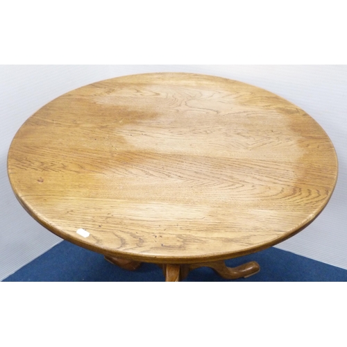 102 - George III style circular oak table with saucer top, on turned column and tripod feet, 77cm high and... 