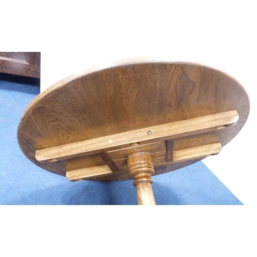 102 - George III style circular oak table with saucer top, on turned column and tripod feet, 77cm high and... 