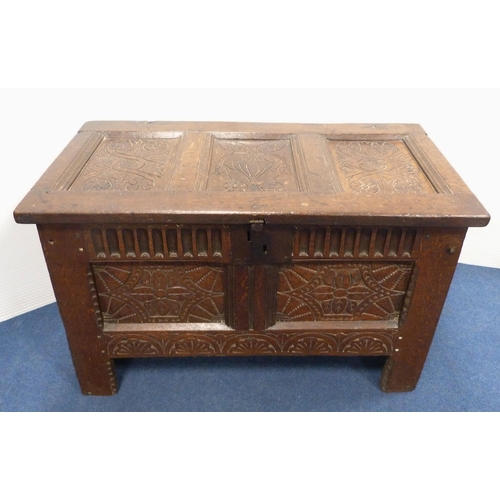 103 - 18th century oak coffer with triple panelled carved hinged top, incised carving to the front, geomet... 